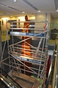 carving maori statue with scaffolding by access one new zealand